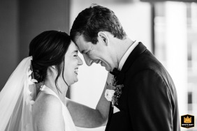 At the Ritz-Carlton Hotel in Chicago, IL, an emotional first look captures the bride and groom face to face, sharing smiles in a black-and-white photograph.